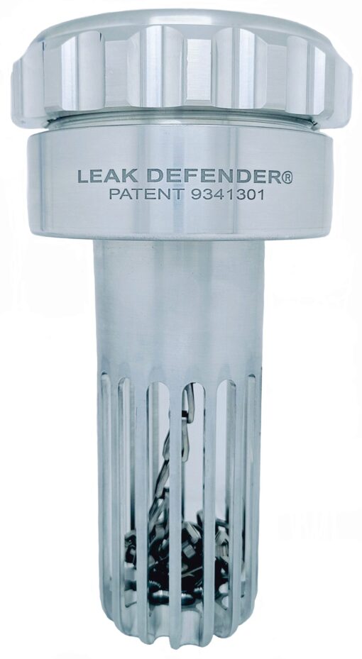 A leak defender device is shown with the words " leak defender " on it.