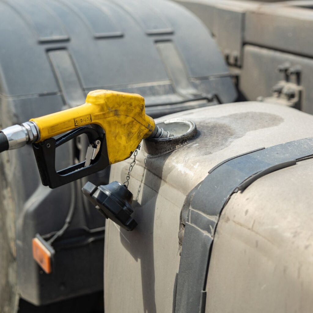 A gas pump is attached to the side of a tanker truck.