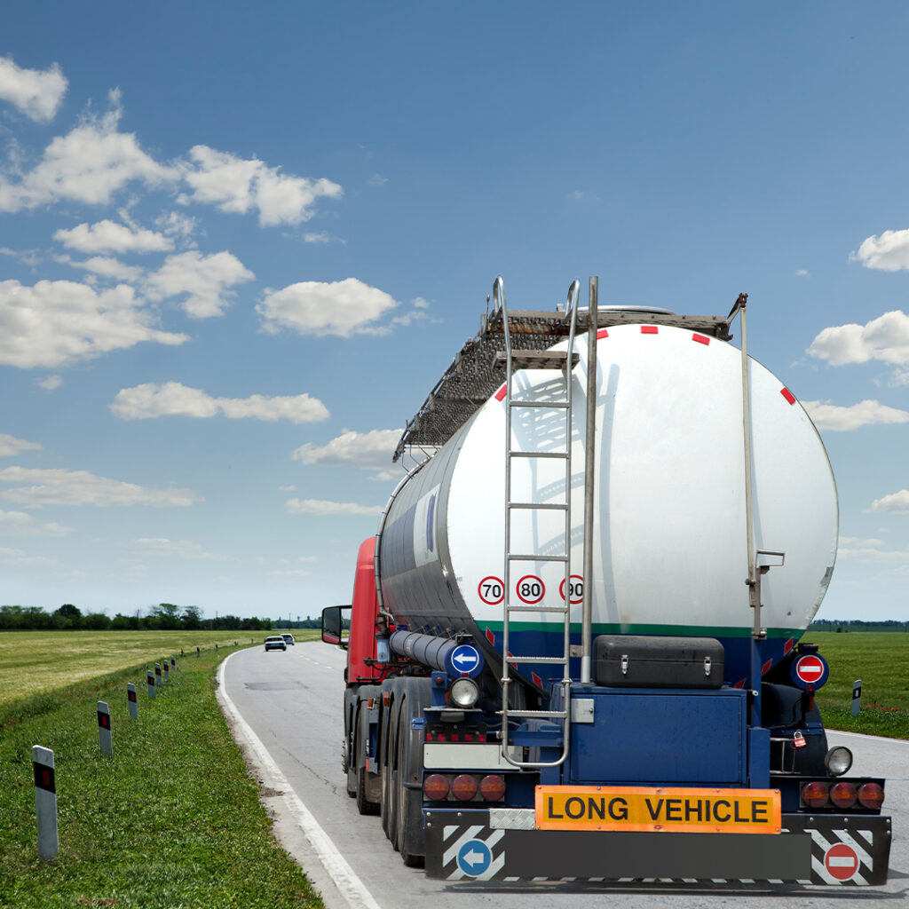 A red and white truck is parked on the side of the road