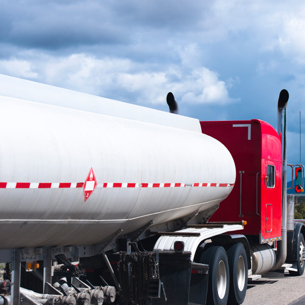 A red and white truck is parked on the side of the road