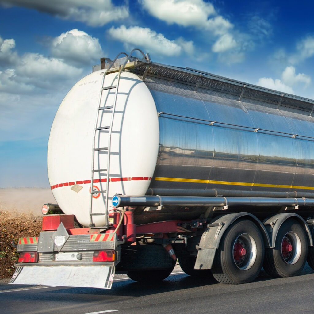 A person pumping gas into the tank of a truck.