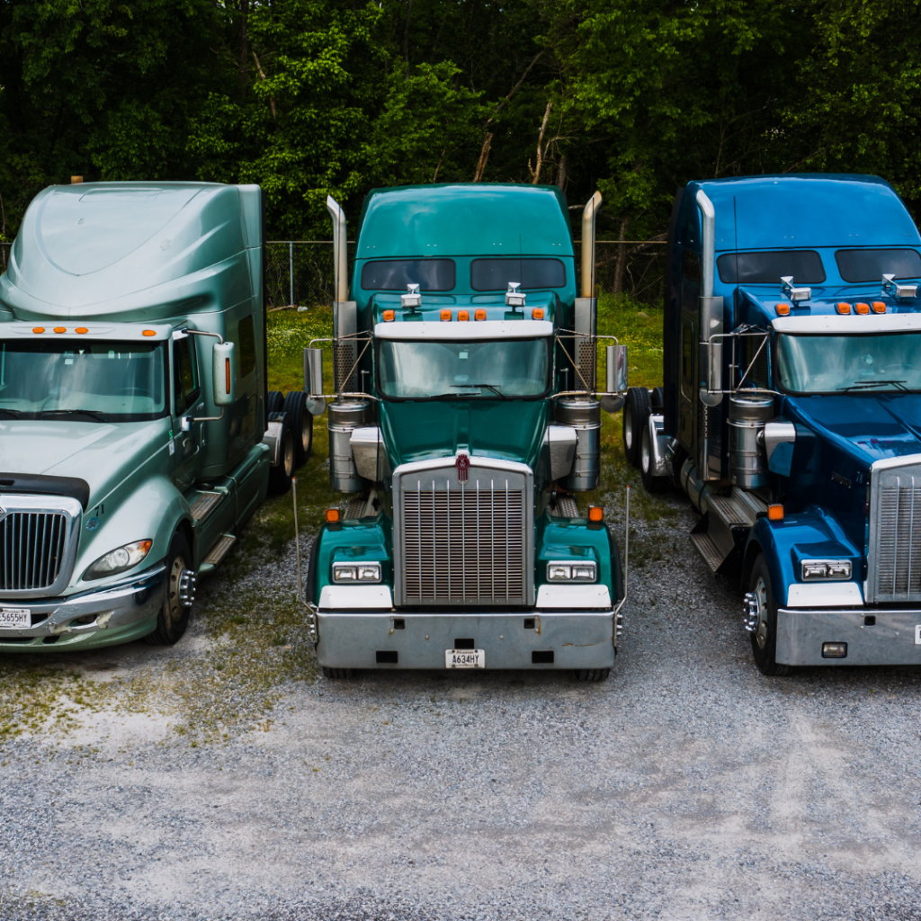 Three semi-trucks parked near each other